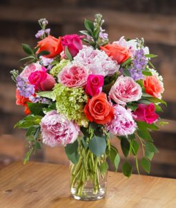 She will love this luxurious presentation featuring Sarah Bernhardt pink peonies, Princess garden roses, hot pink and tuscany-orange roses, fragrant lavender stock, garden hydrangea and lush eucalyptus foliage.