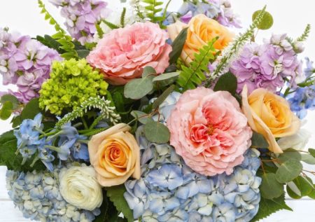 Dreamy pastels of fragrant lavender stock, delicate blue delphiniums, pillowy Italian ranunculus dance with willows of of veronica in a bed of English blush pink garden roses, sun-bleached hydrangea and silver eucalyptus.