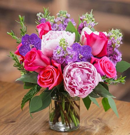  They will love this bouquet of gorgeous fresh pink peonies, fragrant lavender stock, exotic purple orchids, and hot pink candy roses. 