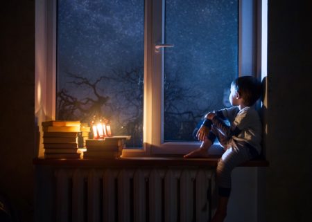 Boy Looking out bedroom window for Star
