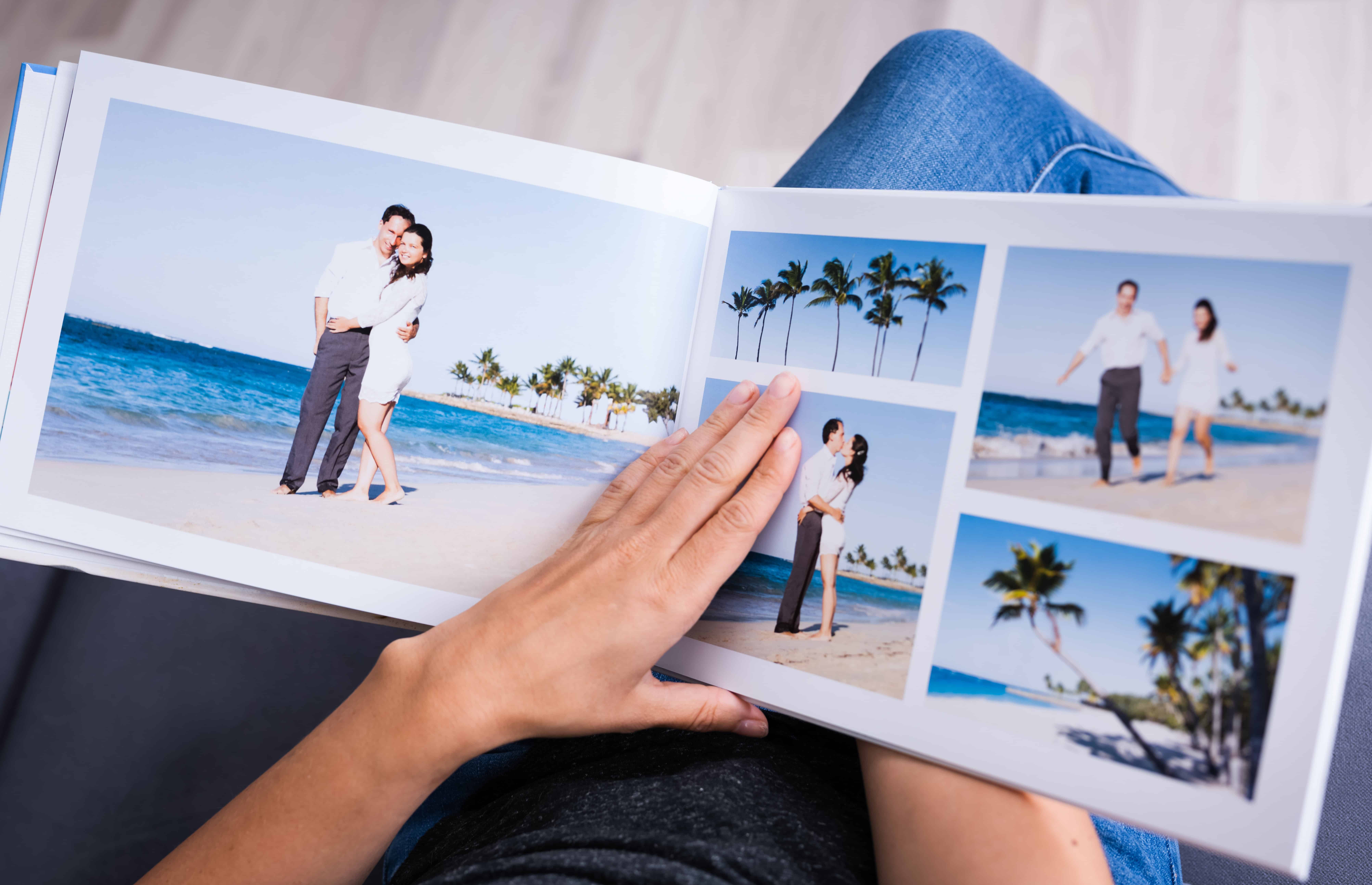 open photo book with pictures of couple at beach