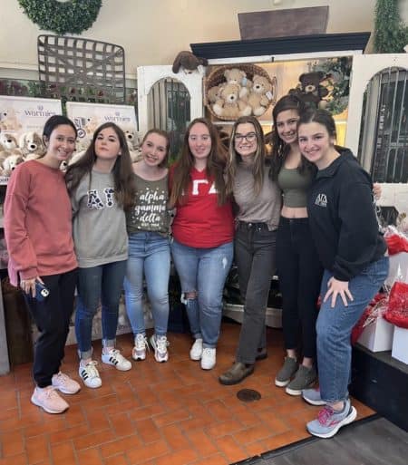 7 sorority girls standing together in Carither's Flower shop