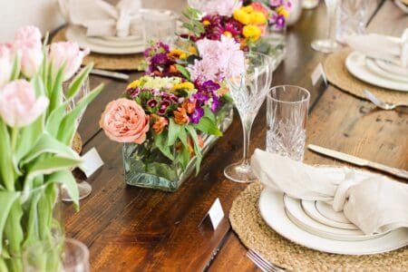Spring Tablescape set for Easter Dinner with bunnies, pottery barn napkins and RH table and chairs.